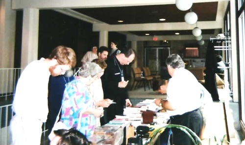 1998070809Checkingthebooktable 2.png